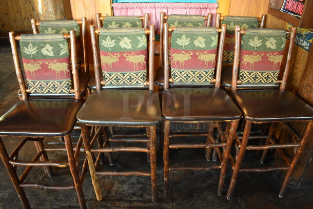 2 Natural Edge Wooden Bar Height Chairs w/ Brown Seat Cushion and Moose / Leaf Backrest. Stock Picture - Cosmetic Condition May Vary. 20x17x48. 2 Times Your Bid!