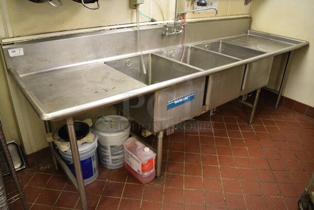 Stainless Steel Commercial 3 Bay Sink w/ Dual Drainboards, Faucet and Handles. BUYER MUST REMOVE. 120x35x43. Bays 20x28x14. Drainboards 27x31x2