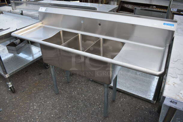 BRAND NEW! BK Stainless Steel Commercial 3 Bay Sink w/ Dual Drainboards on Metal Legs. 60x20x35. Bays 10x14x10. Drainboards 13x16x2 - Image 1 of 3