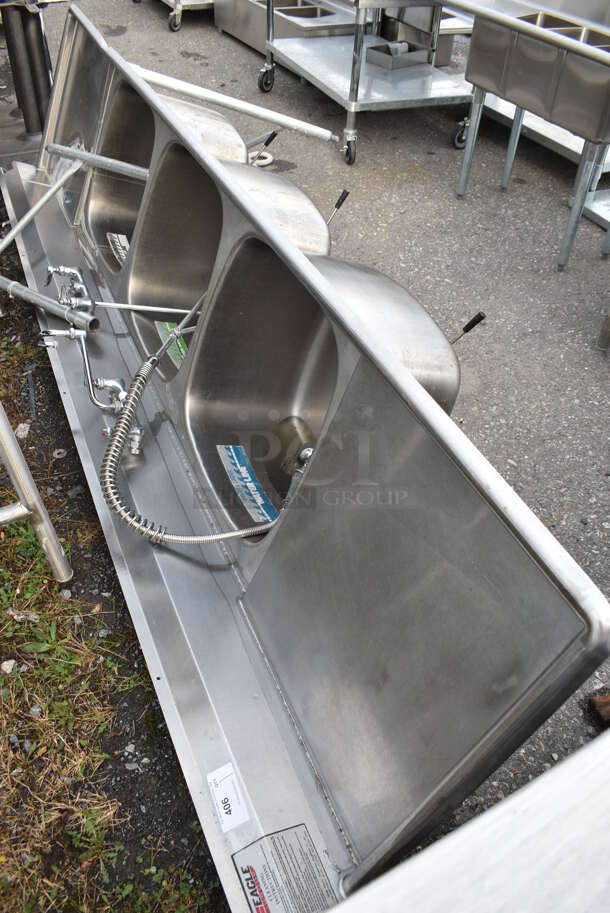 Eagle Stainless Steel Commercial 3 Bay Sink w/ Dual Drainboards, Faucet, Handles and Spray Nozzle Attachment. Legs Need Reattached. 120x30x44. Bays 21x23x13. Drainboards 21x26x2