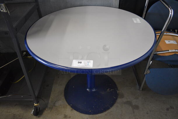 Gray Round Table w/ Blue Rim on Blue Metal Table Base. 36x36x29