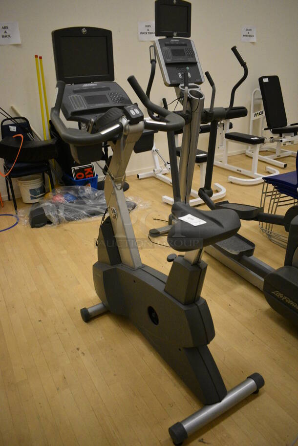 Life Fitness Metal Commercial Floor Style Upright Stationary Bicycle w/ Life Fitness Monitor. BUYER MUST REMOVE. 24x48x63. Working Condition Is Not Known. (behind squash court - right) - Image 2 of 7