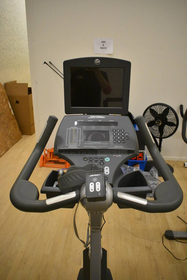 Life Fitness Metal Commercial Floor Style Upright Stationary Bicycle w/ Life Fitness Monitor. BUYER MUST REMOVE. 24x48x63. Working Condition Is Not Known. (behind squash court - right) - Image 4 of 7