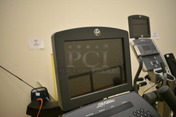 Life Fitness Metal Commercial Floor Style Upright Stationary Bicycle w/ Life Fitness Monitor. BUYER MUST REMOVE. 24x48x63. Working Condition Is Not Known. (behind squash court - right) - Image 6 of 7