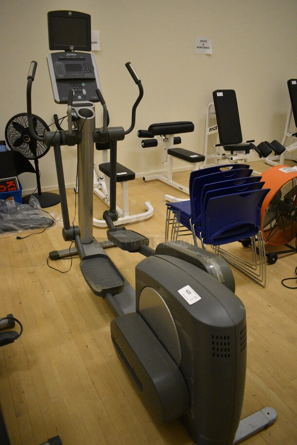Life Fitness Model 95xi Metal Commercial Floor Style Elliptical Cross Trainer w/ Life Fitness Monitor. BUYER MUST REMOVE. 32x82x74. Working Condition Is Not Known. (behind squash court - right)