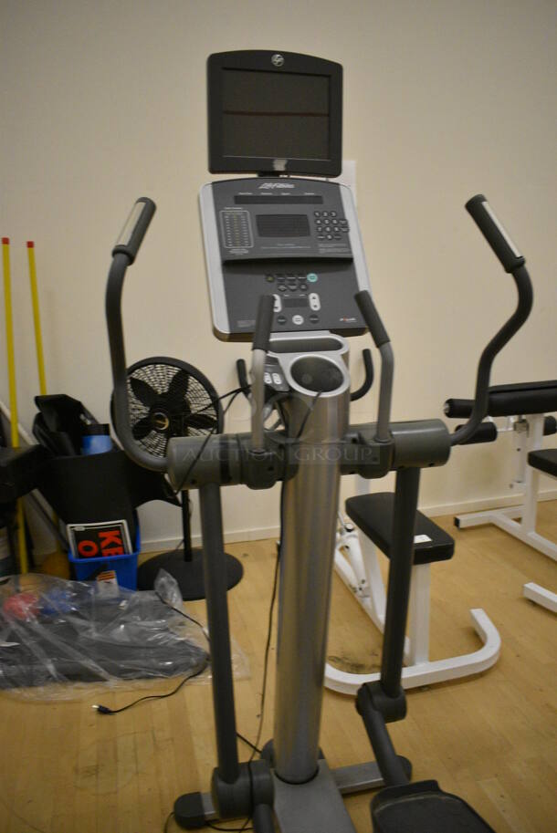 Life Fitness Model 95xi Metal Commercial Floor Style Elliptical Cross Trainer w/ Life Fitness Monitor. BUYER MUST REMOVE. 32x82x74. Working Condition Is Not Known. (behind squash court - right) - Image 5 of 9