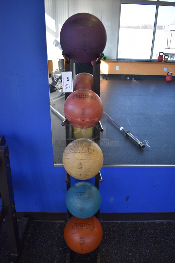 5 First Place Medicine Balls; 2.2 Pound, 4.4 Pound, 6.6 Pound, 8.8 Pound, 11 Pound on Black Metal 5 Tier Medicine Ball Rack. 11x14.5x52. (upstairs)
