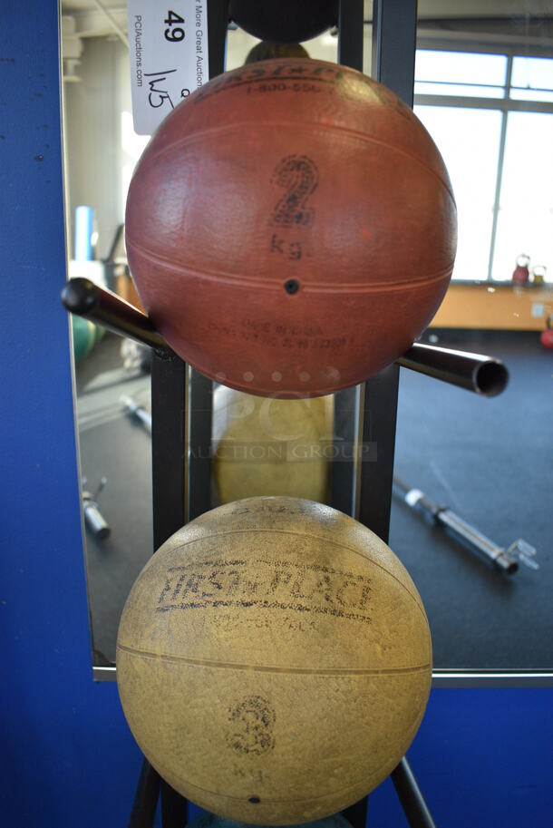 5 First Place Medicine Balls; 2.2 Pound, 4.4 Pound, 6.6 Pound, 8.8 Pound, 11 Pound on Black Metal 5 Tier Medicine Ball Rack. 11x14.5x52. (upstairs)
 - Image 4 of 5
