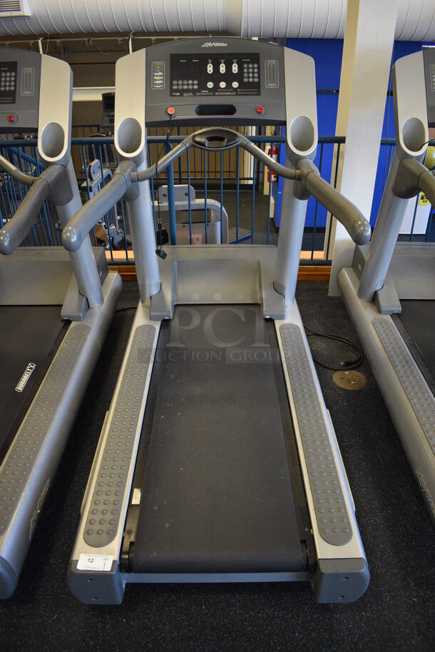NICE! Life Fitness Model 95Ti Metal Heavy Duty Commercial Floor Style Treadmill w/ Heart Rate Sensors and Cup Holders. 120 Volts, 1 Phase. BUYER MUST REMOVE. 36x84x65. Tested and Working! (upstairs) This Unit Will Be Moved Down To The First Floor Before Pick Up Day Begins!
