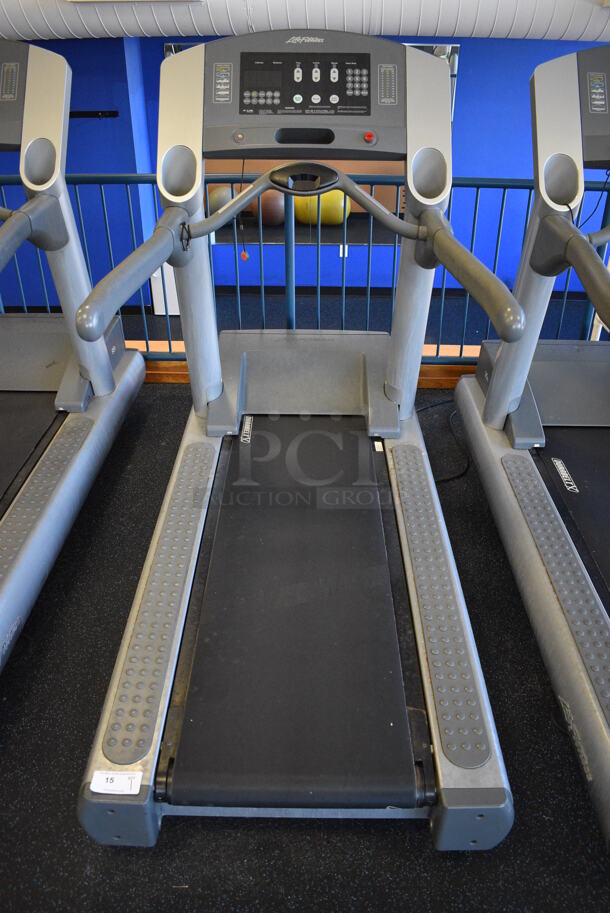 NICE! Life Fitness Model 95T Metal Heavy Duty Commercial Floor Style Treadmill w/ Heart Rate Sensors and Cup Holders. 120 Volts, 1 Phase. BUYER MUST REMOVE. 36x84x65. Tested and Working! (upstairs) This Unit Will Be Moved Down To The First Floor Before Pick Up Day Begins!