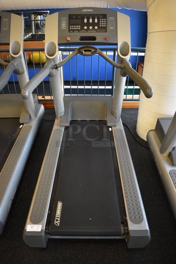 NICE! Life Fitness Model 95T Metal Heavy Duty Commercial Floor Style Treadmill w/ Heart Rate Sensors and Cup Holders. 120 Volts, 1 Phase. BUYER MUST REMOVE. 36x84x65. Tested and Working! (upstairs) This Unit Will Be Moved Down To The First Floor Before Pick Up Day Begins!