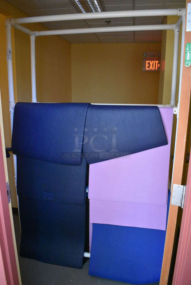 10 Various Exercise / Yoga Mats on White Shelf. BUYER MUST REMOVE. 54x18x83, 24x71. (aerobic room)
