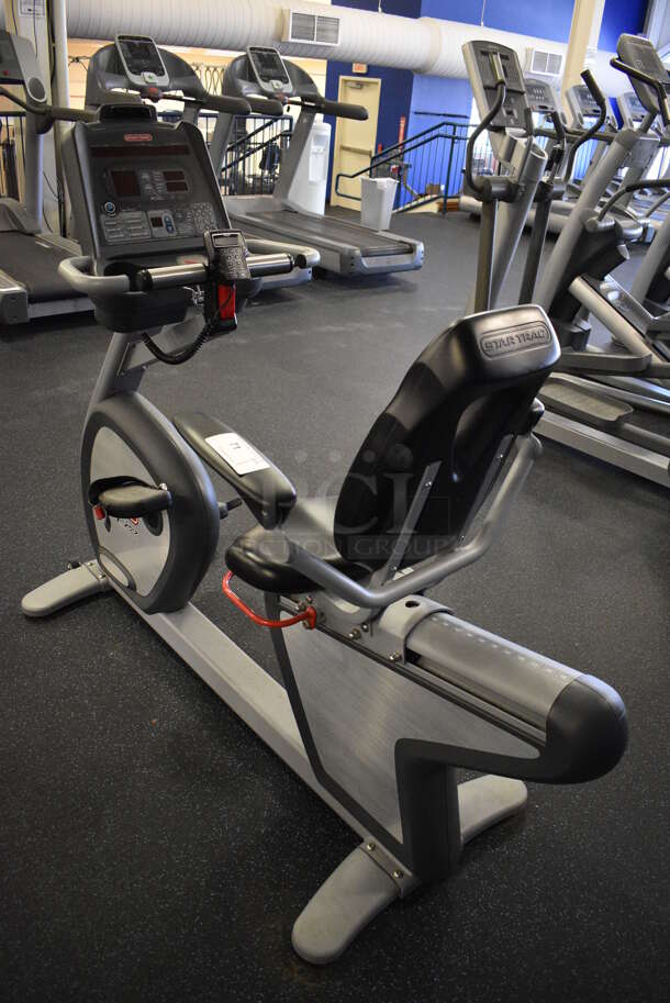 GREAT! Star Trac Pro Model 9-6430-SINTPO Metal Floor Style Seated Stationary Bicycle w/ Heart Rate Sensors, 2 Cup Holders and Arm Rests. BUYER MUST REMOVE. 26x65x53. Tested and Working! (upstairs) This Unit Will Be Moved Down To The First Floor Before Pick Up Day Begins! - Image 1 of 7