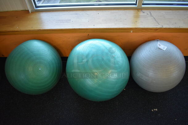 3 Various Stability Balls; 2 Green and 1 Gray. Includes 21x21x21. 3 Times Your Bid! (upstairs)