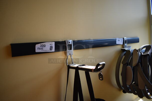 Black Wall Mount Rack. Does Not Come w/ Contents. BUYER MUST REMOVE. 48