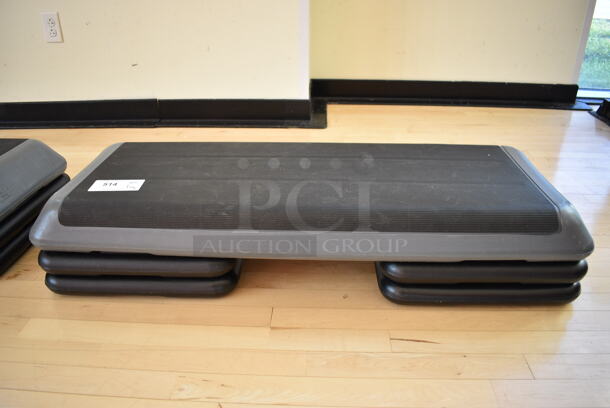 Gray and Black Aerobic Stepper Exercise Work Out Step w/ 4 Risers. Stock Picture - Cosmetic Condition May Vary. 43x15x9. (weight room)