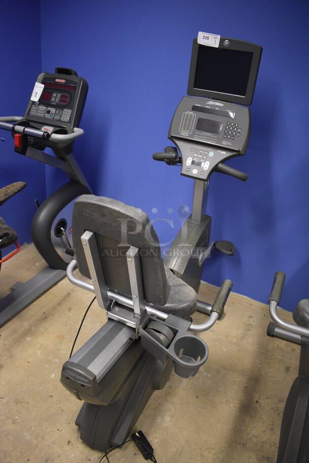 NICE! Life Fitness Metal Commercial Floor Style Seated Stationary Bicycle w/ Life Fitness Monitor. BUYER MUST REMOVE. 27x56x71. Tested and Does Not Power On. (spin cycle room closet)