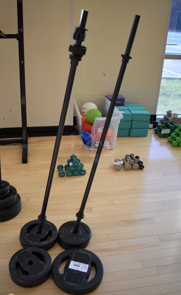 7 Various Les Mills Weight Plates w/ 2 Metal Body Bars; Six 5.5 Pounds and One 11 Pounds. 52