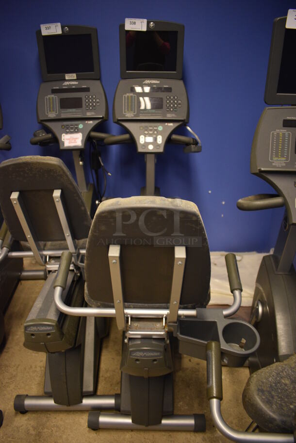 NICE! Life Fitness Metal Commercial Floor Style Seated Stationary Bicycle w/ Life Fitness Monitor. BUYER MUST REMOVE. 27x56x71. Tested and Does Not Power On. (spin cycle room closet)