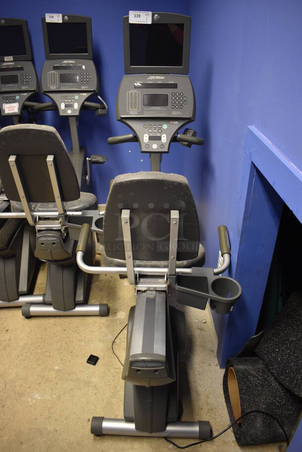 NICE! Life Fitness Metal Commercial Floor Style Seated Stationary Bicycle w/ Life Fitness Monitor. BUYER MUST REMOVE. 27x56x71. Tested and Does Not Power On. (spin cycle room closet)