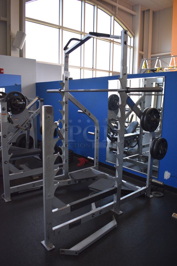 NICE! Hammer Strength Gray Metal Floor Style Squat Rack w/ Olympic Bar. Does Not Include Weight Plates. BUYER MUST REMOVE - Unit May Need Disassembly For Removal. 65x73x91. (weight room) - Image 3 of 9