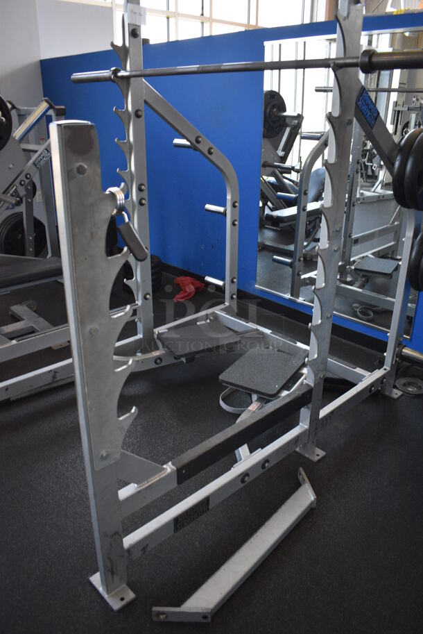 NICE! Hammer Strength Gray Metal Floor Style Squat Rack w/ Olympic Bar. Does Not Include Weight Plates. BUYER MUST REMOVE - Unit May Need Disassembly For Removal. 65x73x91. (weight room) - Image 4 of 9