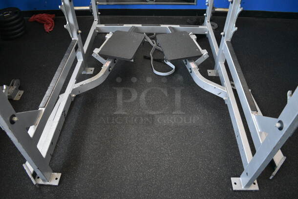 NICE! Hammer Strength Gray Metal Floor Style Squat Rack w/ Olympic Bar. Does Not Include Weight Plates. BUYER MUST REMOVE - Unit May Need Disassembly For Removal. 65x73x91. (weight room) - Image 9 of 9