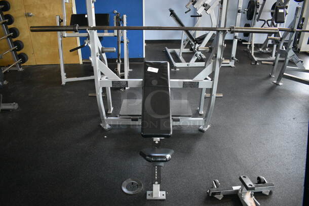 NICE! Hammer Strength Gray Metal Floor Style Incline Bench Press w/ Olympic Bar. BUYER MUST REMOVE - Unit May Need Disassembly For Removal. 66x64x60. (weight room)