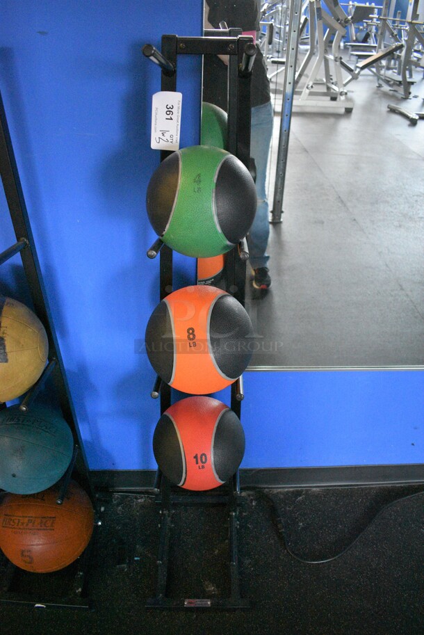 3 Various Medicine Balls; 4 Pound, 8 Pound and 10 Pound on Black Metal 5 Tier Medicine Ball Rack. BUYER MUST REMOVE. 11x14x52. (weight room)