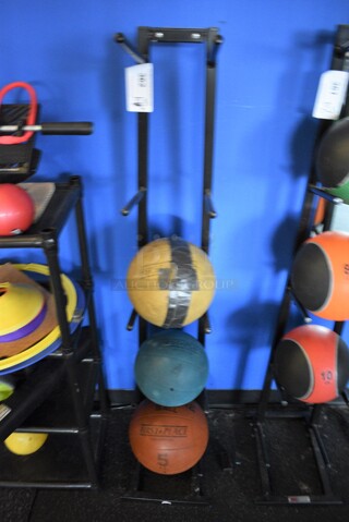 3 Various Medicine Balls; 6.6 Pound, 8.8 Pound and 11 Pound on Black Metal 5 Tier Medicine Ball Rack. BUYER MUST REMOVE. 11x14x52. (weight room)