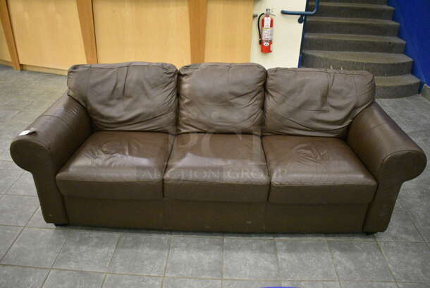 Brown Couch w/ Arm Rests. 85x34x32. (lobby)