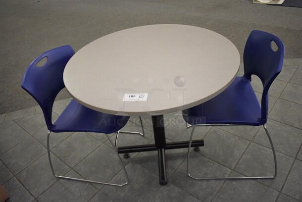 Gray Round Table on Metal Table Base and 2 Blue Chairs. 36x36x30, 20x21x31. (lobby)