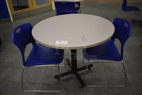 Gray Round Table on Metal Table Base and 2 Blue Chairs. 36x36x30, 20x21x31. (lobby)