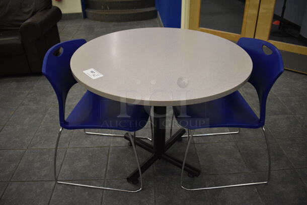 Gray Round Table on Metal Table Base and 2 Blue Chairs. 36x36x30, 20x21x31. (lobby)