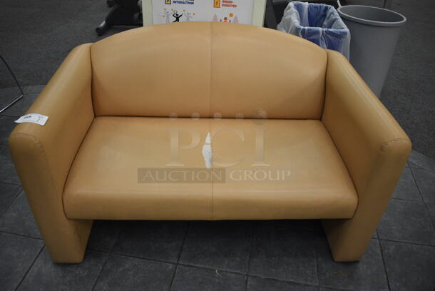 Tan Couch. 53x30x32. (lobby)