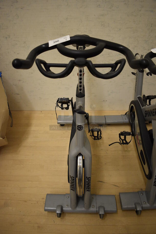 NICE! Star Trac Spinner NXT Metal Commercial Floor Style Upright Stationary Bicycle. BUYER MUST REMOVE. 21x47x45. Working Condition Is Not Known. (behind squash court - left) - Image 1 of 4