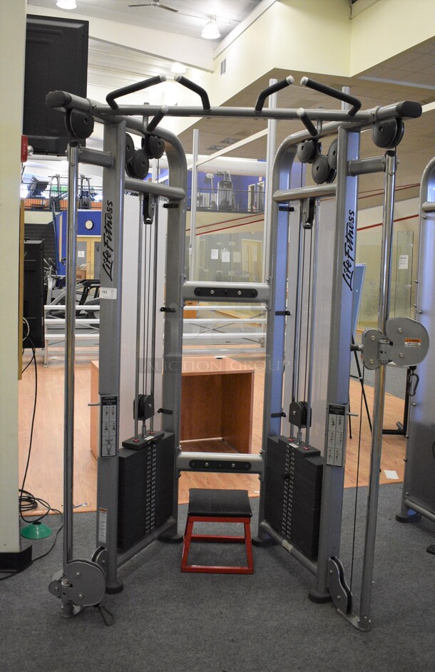 Life Fitness Model CMDAP Gray Metal Floor Style Dual Adjustable Pulley Functional Trainer Machine. BUYER MUST REMOVE - Unit May Need Disassembly For Removal. 64x48x93. (lobby)