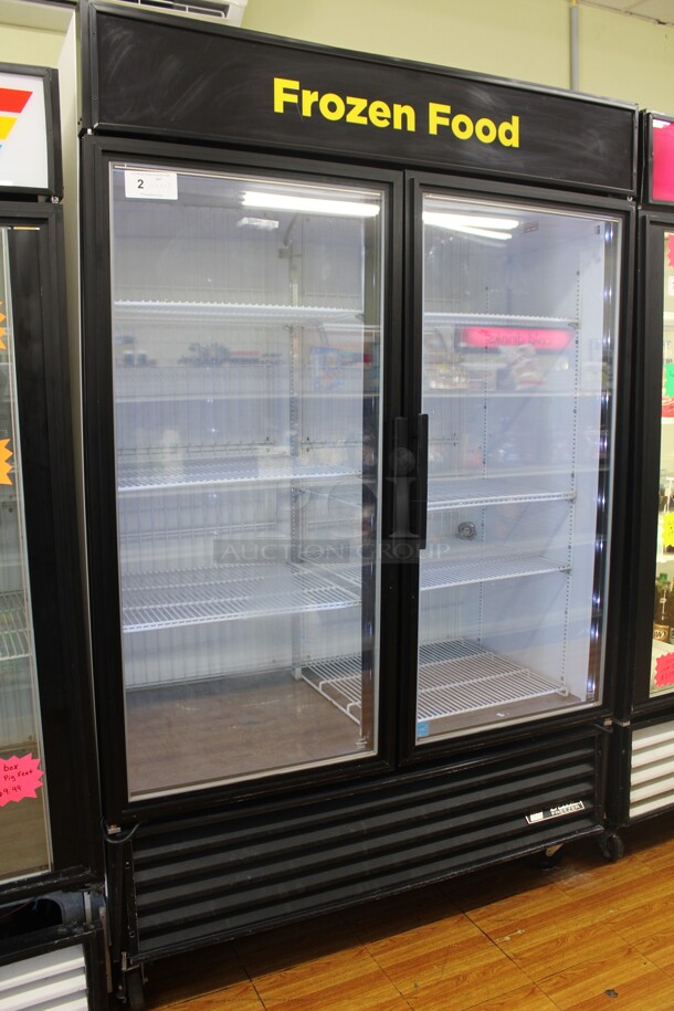 FANTASTIC! True Model GDM-49F-LD Commercial Double Glass Door Lighted Freezer Merchandiser On Commercial Casters. 53.5x30x83. Hardwired! 115/208-230V. 60Hz. 1 Phase. Tested And Working! Buyer Must Remove.Shipping Is Not Available.  - Image 1 of 5