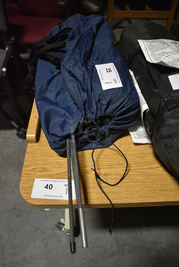 Blue Bag w/ Tent and Poles. 20x9x9. (facilities)