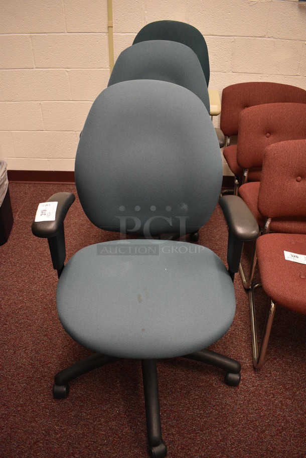 3 Blue Office Chairs w/ Arm Rests on Casters. 23x22x40. 3 Times Your Bid! (Whitaker Hall - Room 132 - Office A)