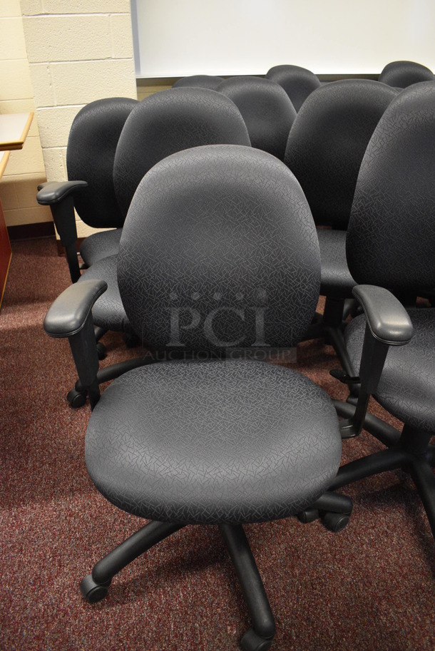 6 Black Office Chairs w/ Arm Rests on Casters. Stock Picture - Cosmetic Condition May Vary. 24x21x39. 6 Times Your Bid! (John N. Hall Tech - Room 101)