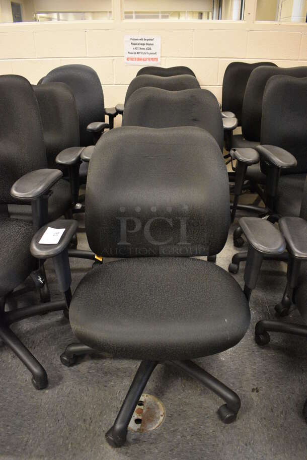 6 Black Office Chairs w/ Arm Rests on Casters. Stock Picture - Cosmetic Condition May Vary. 24x21x39. 6 Times Your Bid! (John N. Hall Tech - Room 102)