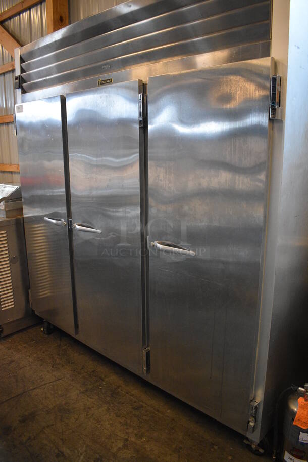 GREAT! Traulsen Model G31310 Stainless Steel Commercial 3 Door Reach In Freezer w/ Poly Coated Racks on Commercial Casters. 115/208 Volts, 1 Phase. 76x34x83