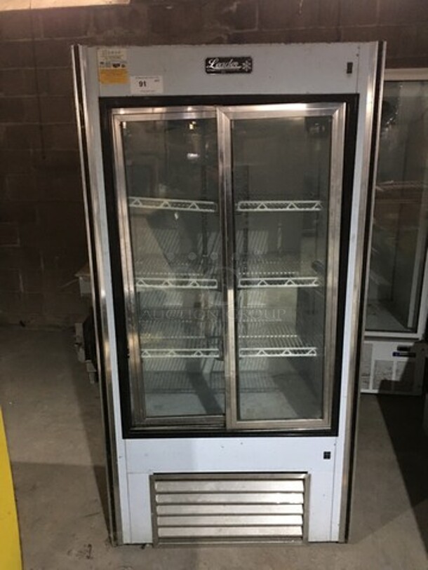 Leader Reach In Cooler Merchandiser! With 2 Glass Sliding Doors! With Poly Coated Racks! Model LS38SC Serial PZ01C1816! 115V 1 Phase!