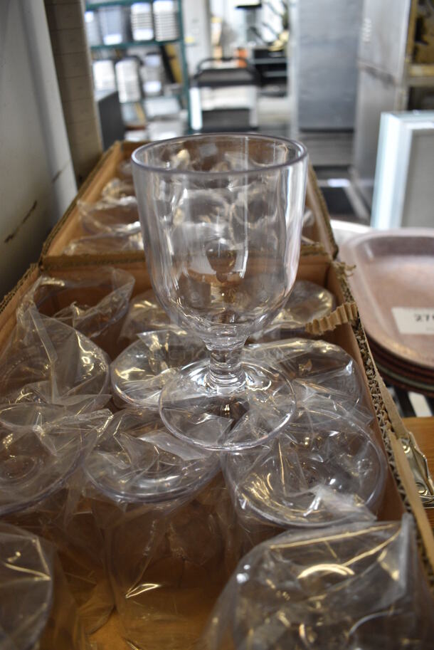 12 BRAND NEW IN BOX! Clear Poly Wine Glasses. 3x3x5.5. 12 Times Your Bid!
