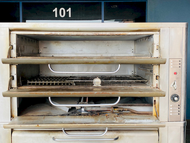 PRISTINE!! Blodgett 981 Natural Gas Multi-Purpose Double Deck Oven with Draft Diverter - 100,000 BTU. On Commercial Casters.    Can be used for: roasts, pastries, cakes, artesian breads, pizzas, and more 42"W x 32"D deck interior, (4) sections, consists of (4) 7" high baking compartments per section, (FTDO) 200-500°F mechanical thermostat, counter-balanced doors with heavy chrome handle, angle iron frame, steel deck, crown angle trim, aluminized steel interior, stainless steel top, front, sides and back  Overall Dimensions: Width: 60" Depth: 38 1/2" Height: 68 13/16" Interior Dimensions (Per Oven): Width: 42" Depth: 32" Height: 7" Deck Thickness: 1" - Image 4 of 11
