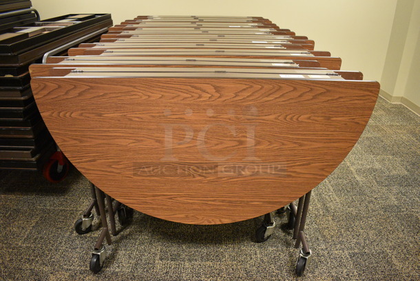 5 Wood Pattern Round Fold Up Tables on Commercial Casters. Makes a 60x60 Table. 60x18x39. 5 Times Your Bid! (Midtown 2: Second Floor: Room 206D)