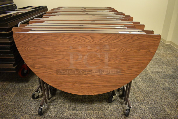 4 Wood Pattern Round Fold Up Tables on Commercial Casters. Makes a 60x60 Table. 60x18x39. 4 Times Your Bid! (Midtown 2: Second Floor: Room 206D) - Image 1 of 5