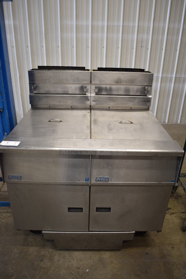 AMAZING! 2015 Pitco Frialator Model SG18 Stainless Steel Commercial Natural Gas Powered 2 Bay Deep Fat Fryer w/ 2 Lids and Filtration System on Commercial Casters. 140,000 BTU. 40x35x48
