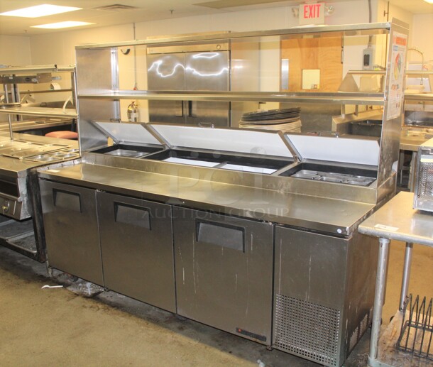 AWESOME! True Model TPP-93 Commercial Stainless Steel 3 Door Pizza Prep Table On Commercial Casters With Shelf.  - Image 1 of 9